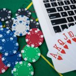 Casino Chips and Playing Cards on Laptop Computer for Virtual Poker Betting and Gambling Strategy