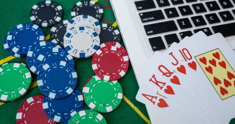 Casino Chips and Playing Cards on Laptop Computer for Virtual Poker Betting and Gambling Strategy