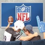 Father and son watching broadcast NFL on TV