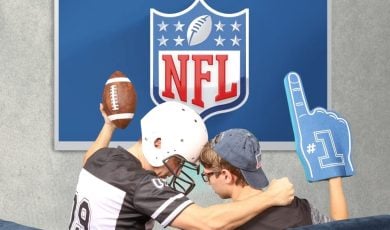 Father and son watching broadcast NFL on TV