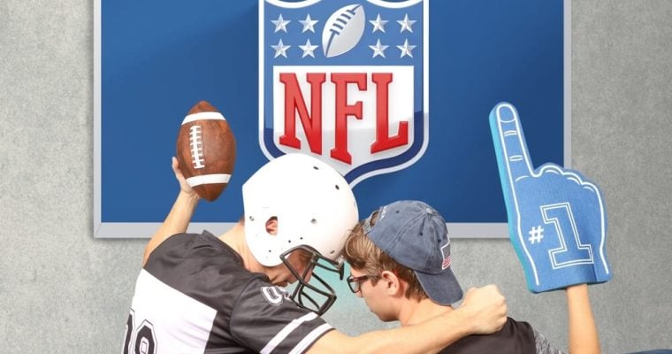 Father and son watching broadcast NFL on TV