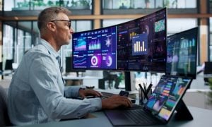 Financial Analyst Pointing At Predictive Dashboard While Monitoring Market Trends Data