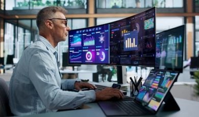 Financial Analyst Pointing At Predictive Dashboard While Monitoring Market Trends Data