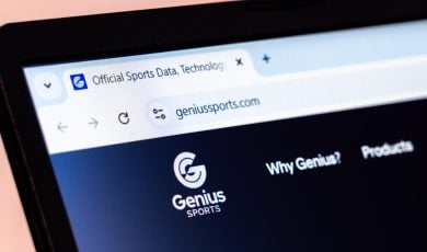 Genius Sports company website homepage displayed with logo on laptop screen