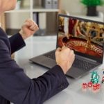 Guy with poker chips on table, playing an online casino game