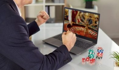 Guy with poker chips on table, playing an online casino game