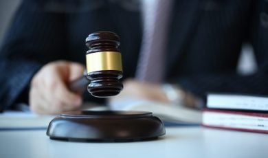 Judge holding hammer in hand lies