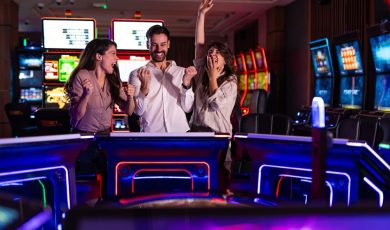 Three cheerful friends enjoy a fun time at a vibrant casino arcade