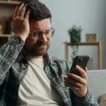 guys placing bets at a sports betting platform and losing, disappointed