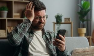 guys placing bets at a sports betting platform and losing, disappointed