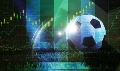 soccer ball on grass with financial stock market chart overlay, sports betting odds