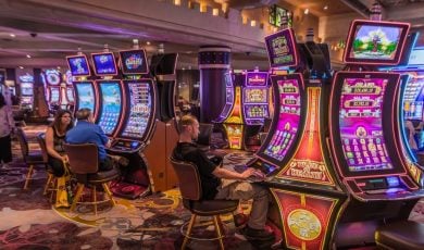 tourists gambling at slot machines inside the fancy casino in Las Vegas