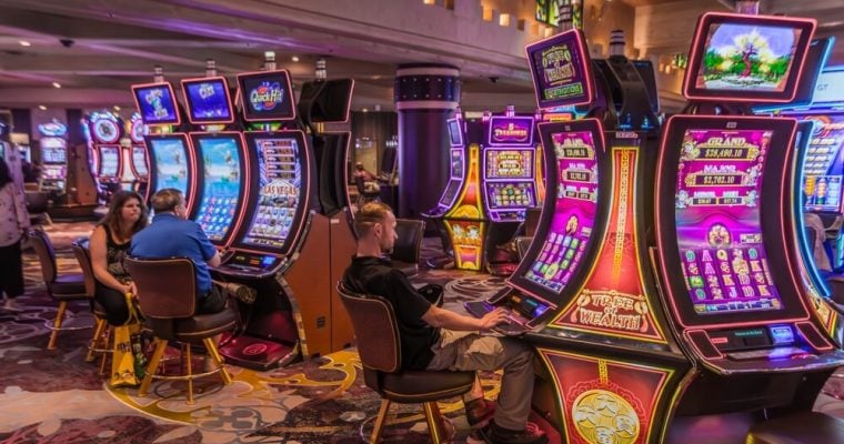 tourists gambling at slot machines inside the fancy casino in Las Vegas