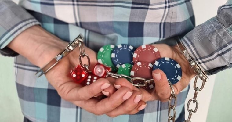Casino chips dice and persons in handcuffs