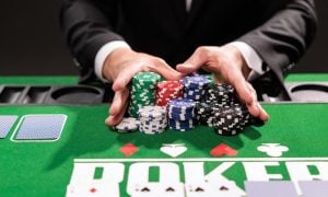 Poker player going all in pushing his chips forward