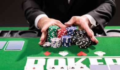 Poker player going all in pushing his chips forward