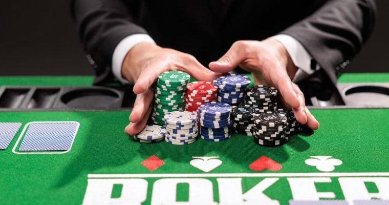 Poker player going all in pushing his chips forward
