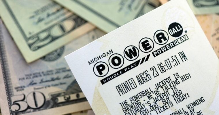 Power Ball lottery ticket lies on many dollar bills close up