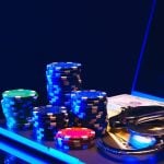 Stacks of Casino Chips and Handcuffs on Laptop Keyboard