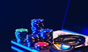Stacks of Casino Chips and Handcuffs on Laptop Keyboard
