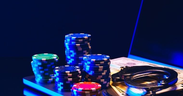 Stacks of Casino Chips and Handcuffs on Laptop Keyboard