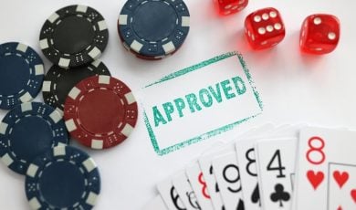 Stamp approved standing near playing cards and chips in casino with dice closeup