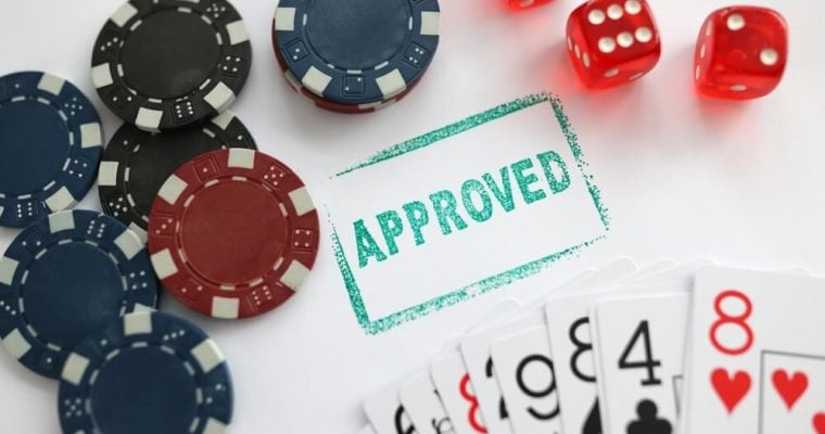 Stamp approved standing near playing cards and chips in casino with dice closeup