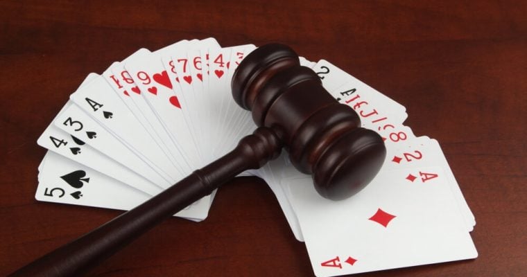 Wooden judge gavel on playing cards deck close up